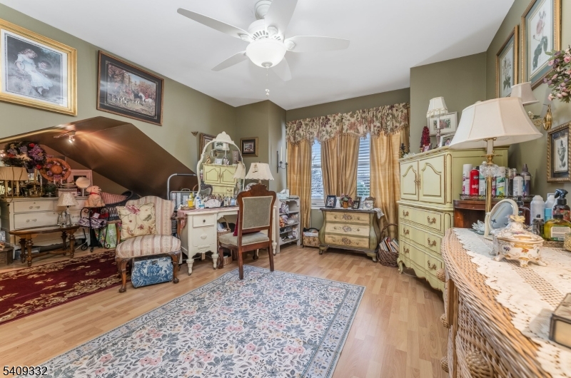 7 Rachel Court Clinton, NJ 08809 - Photo 22 of 42 a living room with furniture and a chandelier