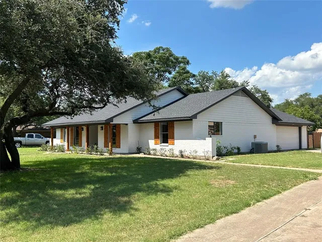 a house that has a big yard and large trees