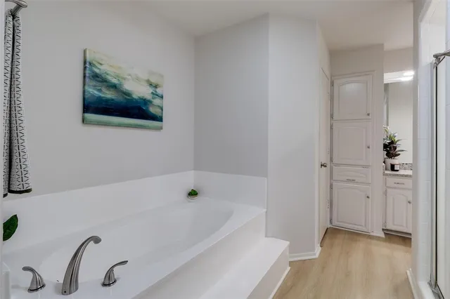 a bathroom with a tub and shower