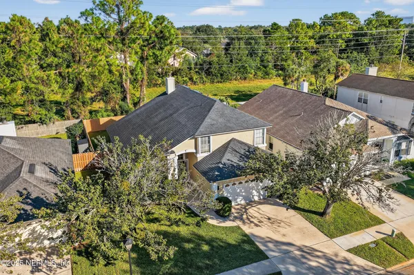 an aerial view of a house with a yard