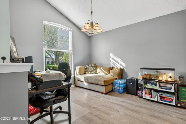 a living room with furniture a piano and a flat screen tv