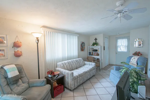 a view of a livingroom with wooden floor and a window