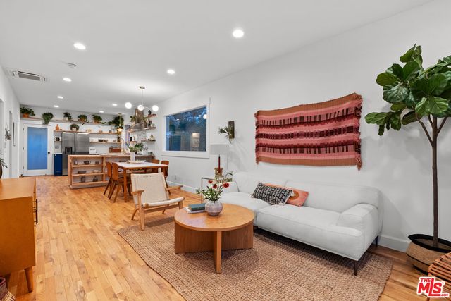 a living room with furniture kitchen view and a table