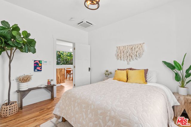 a bedroom with a bed and a potted plant