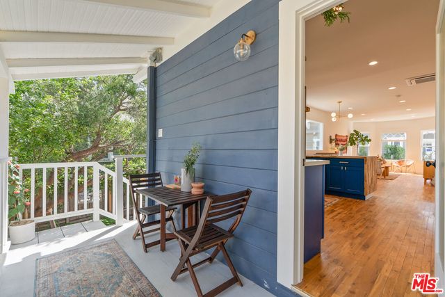 a view of a chairs and table in the balcony