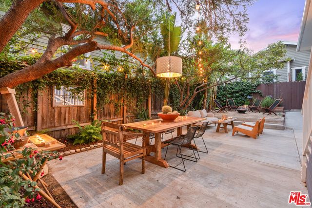a backyard of a house with table and chairs