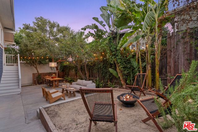 a view of a backyard with sitting area