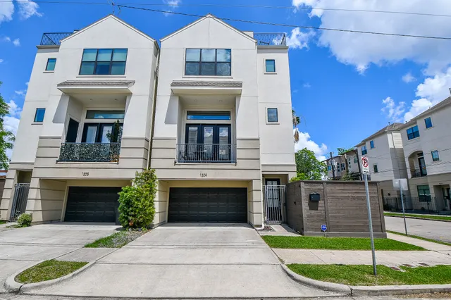 a front view of a house with a garden and plants