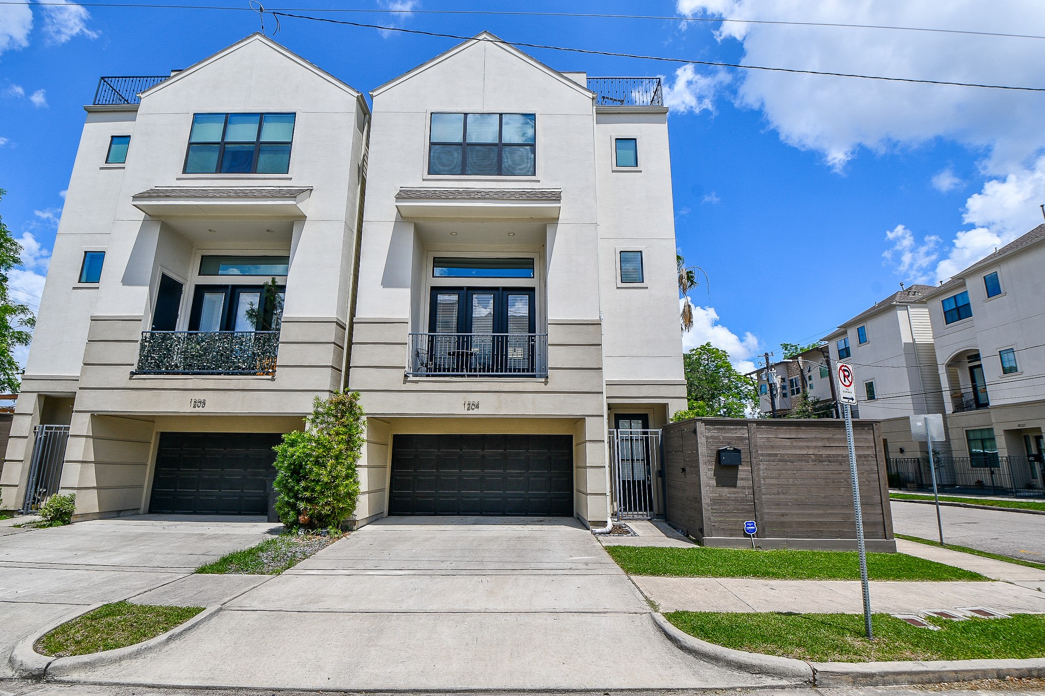 a front view of a house with a garden and plants