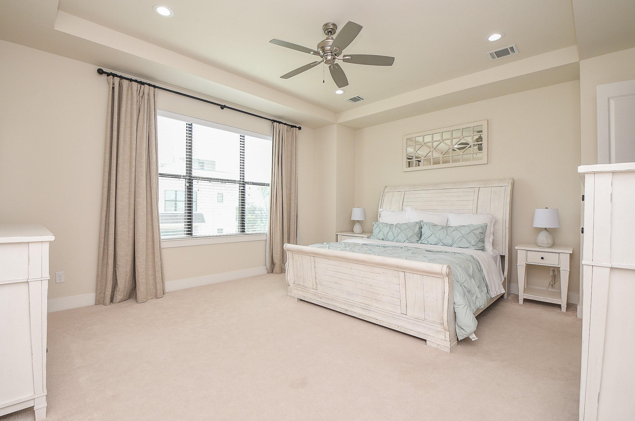1204 Fowler Street Houston, TX 77007 - Photo 14 of 25 a spacious bedroom with a large bed and a chandelier