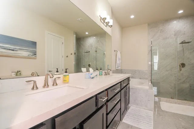 a bathroom with a sink double vanity and shower