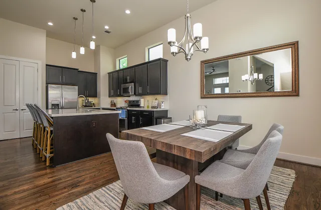 a view of a dining room with furniture a chandelier and wooden floor