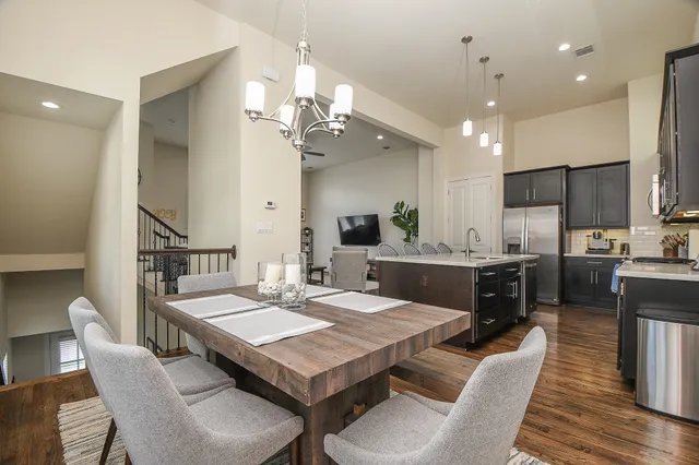 a large kitchen with a table and chairs