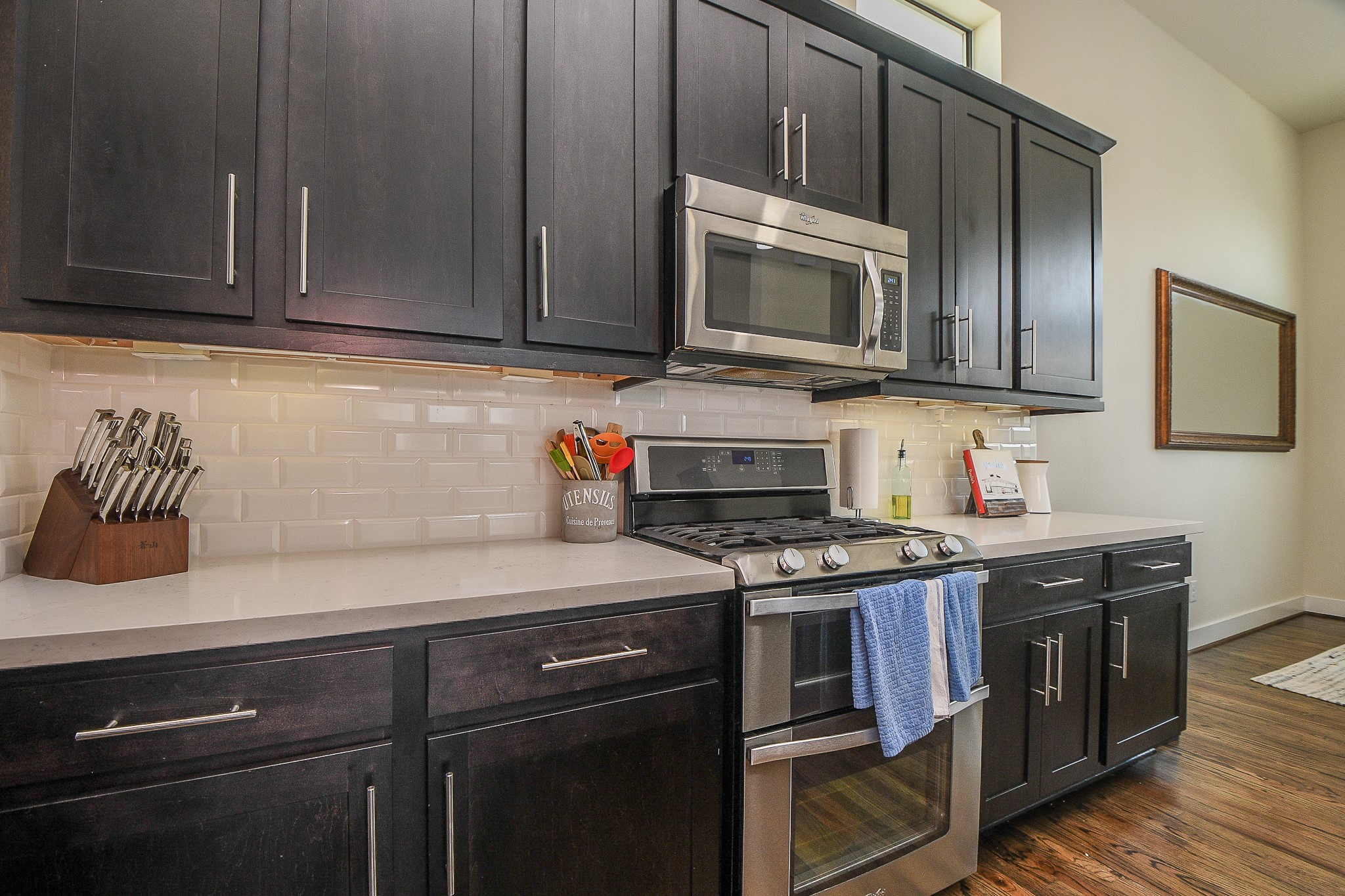 1204 Fowler Street Houston, TX 77007 - Photo 8 of 25 a kitchen with stainless steel appliances granite countertop a stove microwave and cabinets