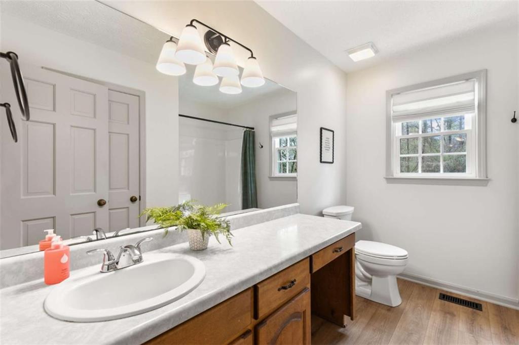 138 Adams Road Fayetteville, GA 30214 - Photo 16 of 38 a bathroom with a sink a toilet and a mirror