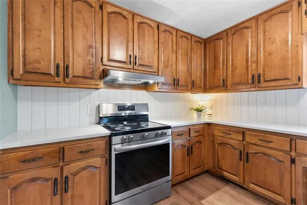 a kitchen with granite countertop cabinets stainless steel appliances and sink