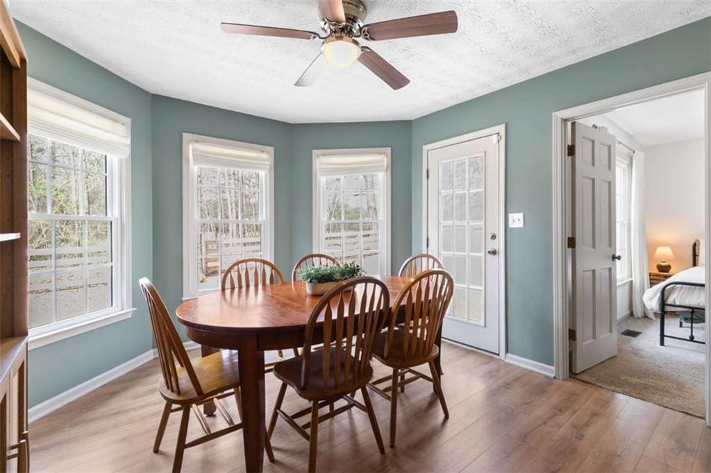 138 Adams Road Fayetteville, GA 30214 - Photo 25 of 38 a dining room with furniture a chandelier and wooden floor