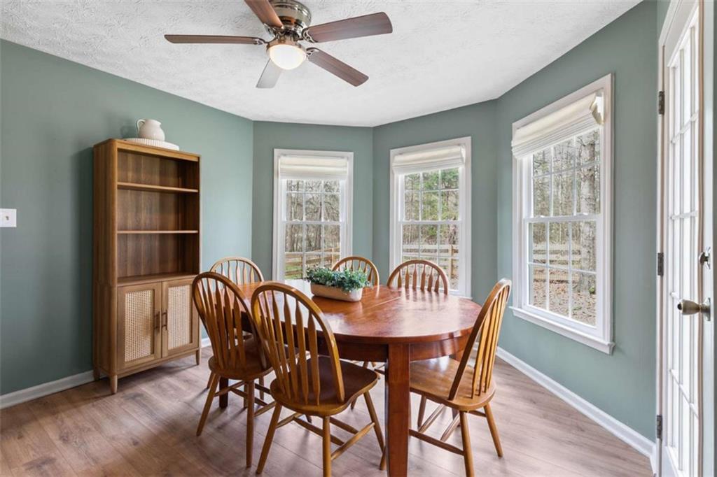 138 Adams Road Fayetteville, GA 30214 - Photo 26 of 38 a view of a dining room with furniture window and wooden floor