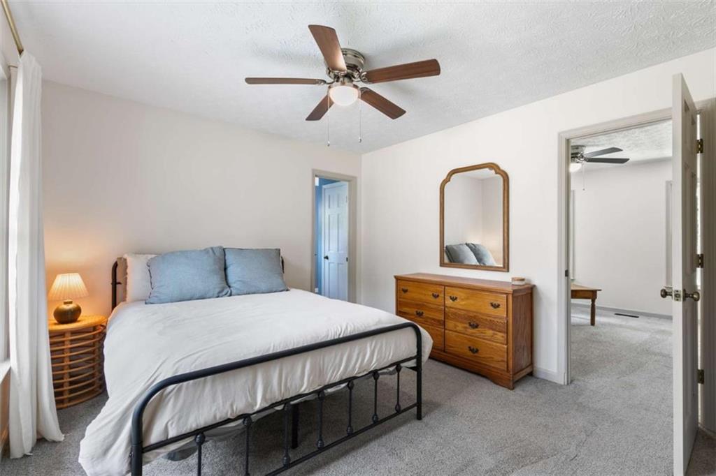 138 Adams Road Fayetteville, GA 30214 - Photo 27 of 38 a bedroom with a bed and a dresser