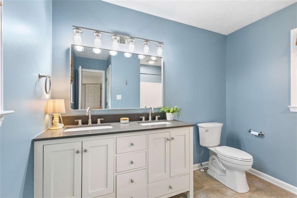 138 Adams Road Fayetteville, GA 30214 - Photo 30 of 38 a bathroom with a double vanity sink mirror and toilet