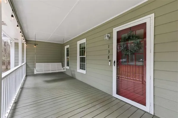 a view of a porch with wooden floor and brick wall