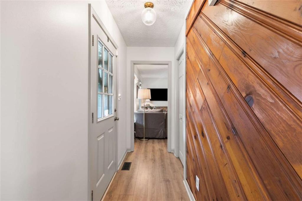 138 Adams Road Fayetteville, GA 30214 - Photo 6 of 38 a view of a hallway with wooden floor and staircase