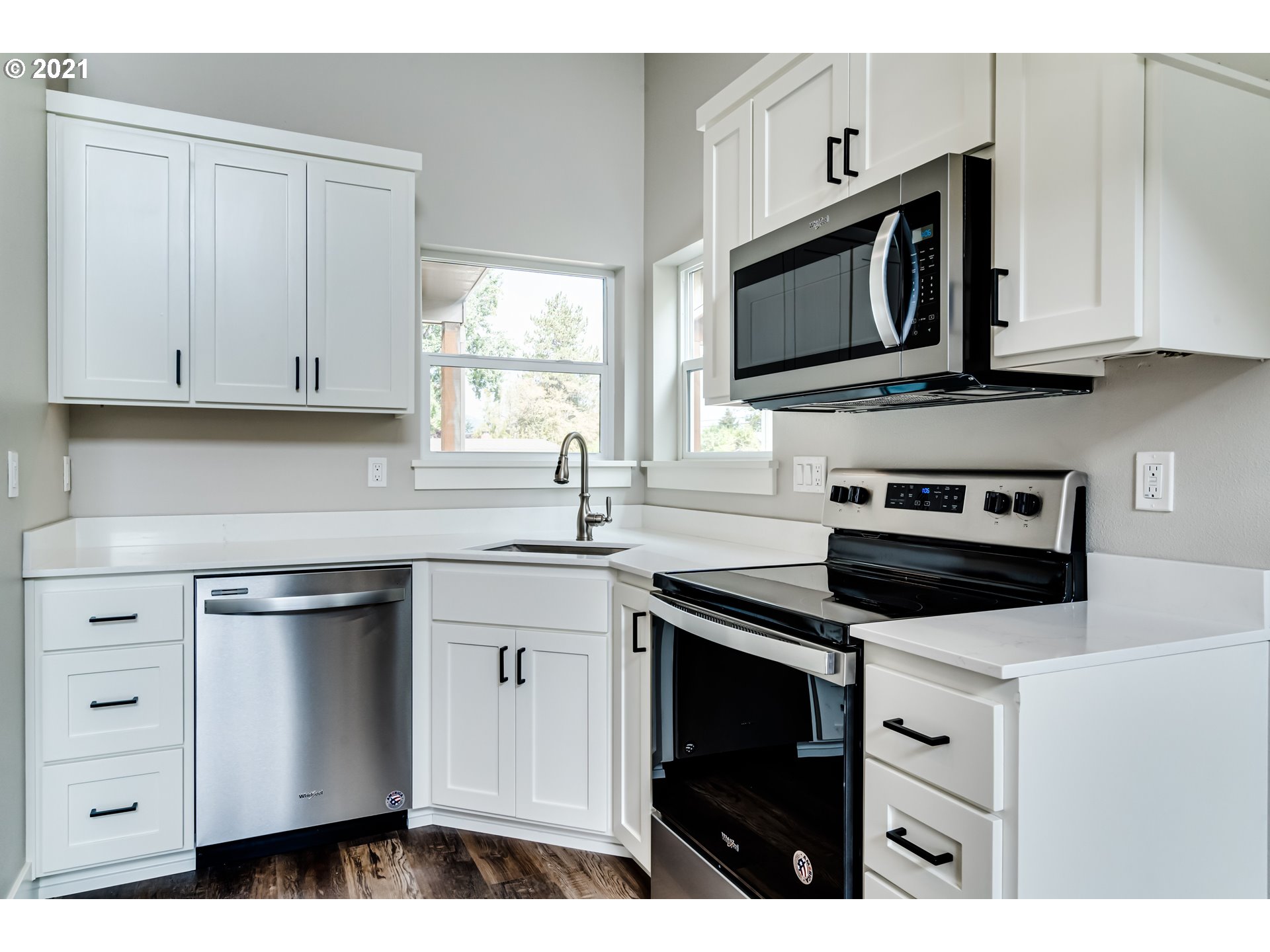 380 19th Springfield, OR 97477 - Photo 2 of 24 a kitchen with stainless steel appliances granite countertop white cabinets a stove a sink and dishwasher