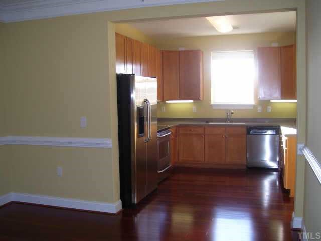 3811 Lunceston Way, Unit 307 Raleigh, NC 27613 - Photo 6 of 10 Seperate dining room features the brazilian cherry hardwoods thru out the kitchen, solid surface countertops, stainless steel applicances and refridgerator.