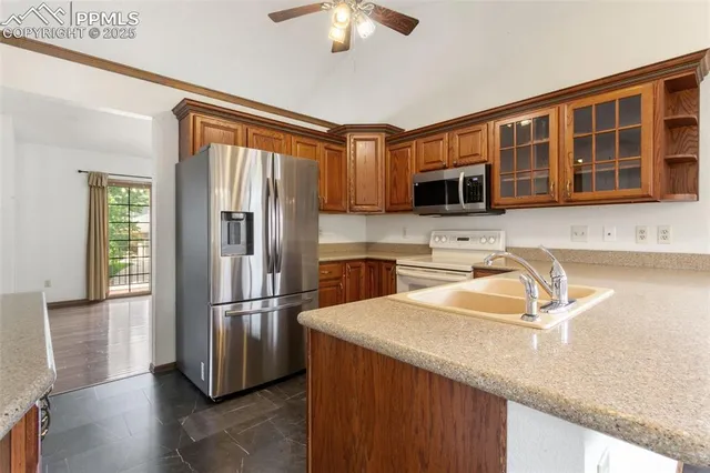a kitchen with granite countertop a refrigerator and a sink