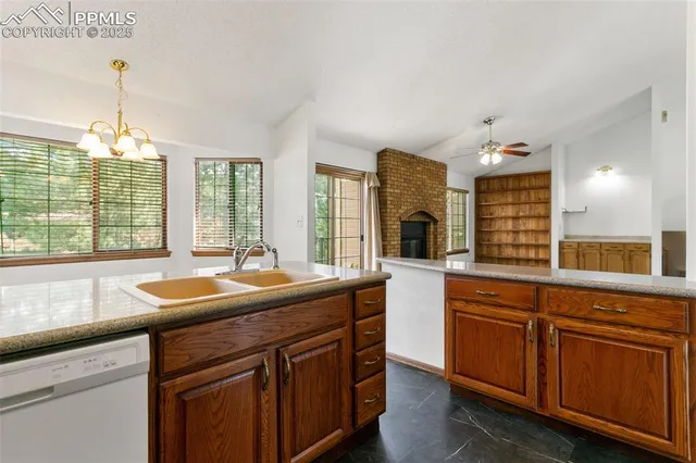 a kitchen with granite countertop kitchen island a sink and a large window