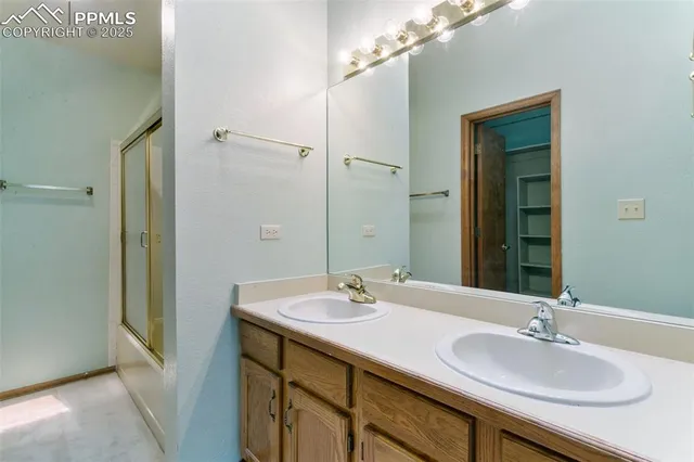 a bathroom with a sink double vanity and a mirror