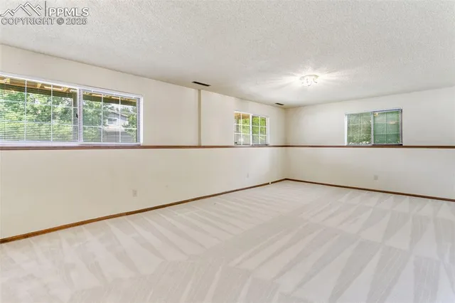 an empty room with a empty space and windows