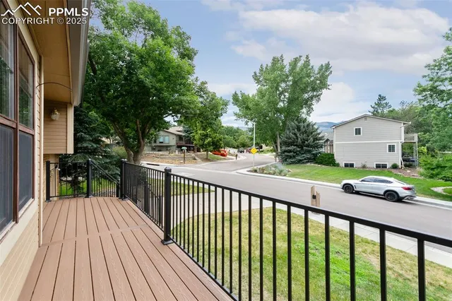 a view of a street with wooden fence