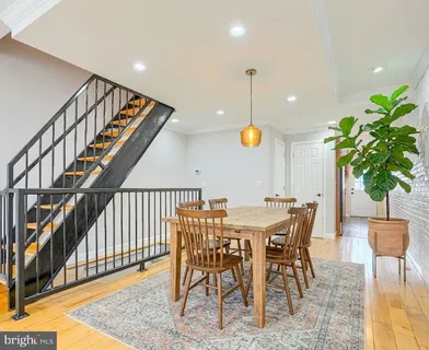 a kitchen with stainless steel appliances granite countertop a stove top oven a sink dishwasher and a refrigerator with wooden cabinets