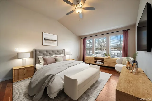 a spacious bedroom with a bed and glass window