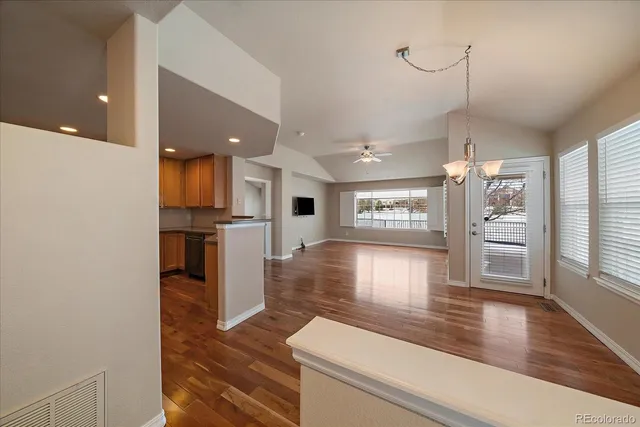 a kitchen with stainless steel appliances granite countertop a refrigerator a sink and a stove