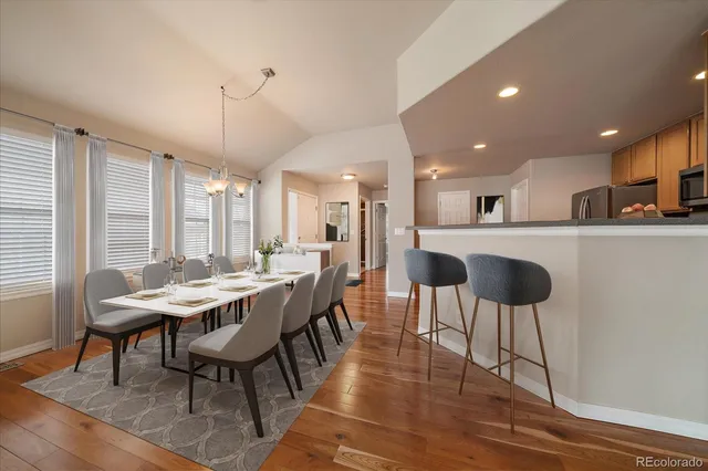 a large kitchen with a table and chairs
