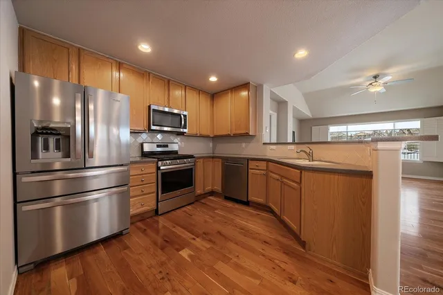 a kitchen with stainless steel appliances and wooden cabinets
