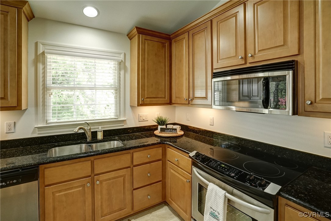 10132 Forest Patch Drive Mechanicsville, VA 23116 - Photo 13 of 43 a kitchen with granite countertop a sink a stove and cabinets