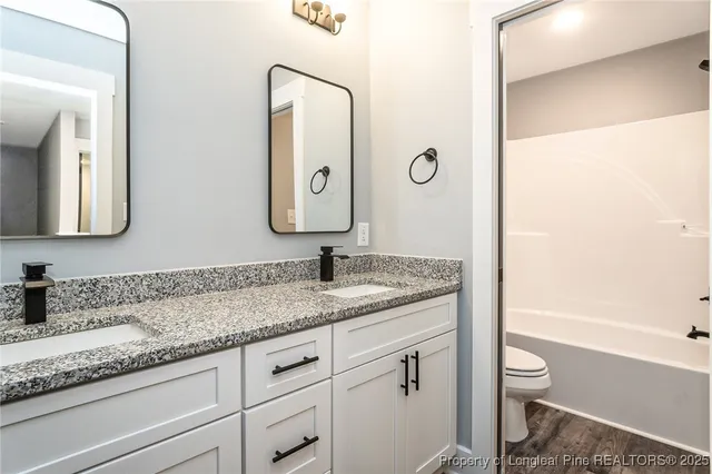 a white toilet sitting next to a bath tub