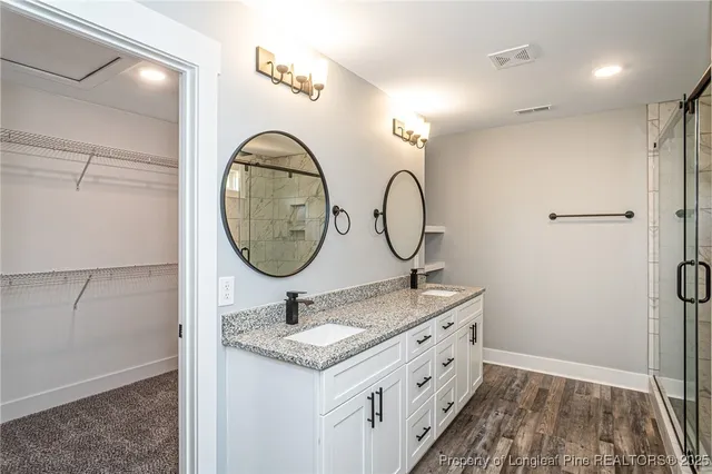 a bathroom with a glass shower door