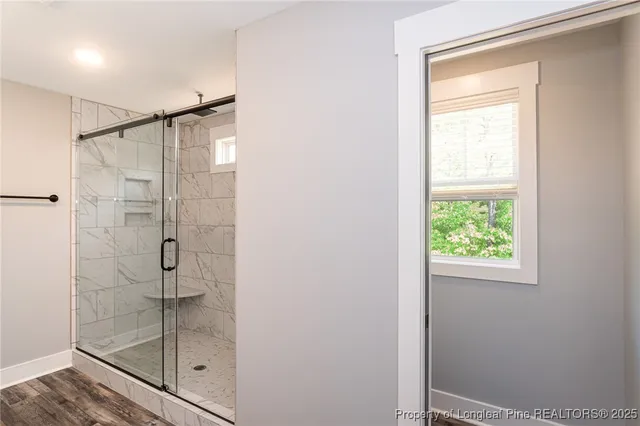 a bathroom with a granite countertop double vanity sink and a mirror