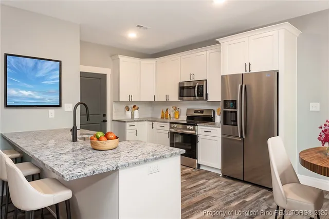 a kitchen with a refrigerator a stove and a cabinets
