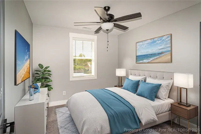 a bedroom with bed and a potted plant