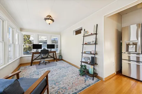 a view of a workspace with furniture and a window