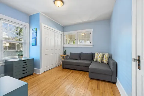 a living room with furniture and wooden floor