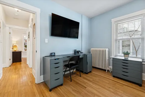 a view of a workspace with furniture and a flat screen tv