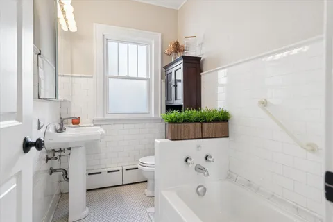 a bathroom with a bathtub sink and toilet
