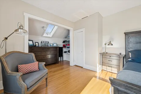 a living room with furniture and a dresser