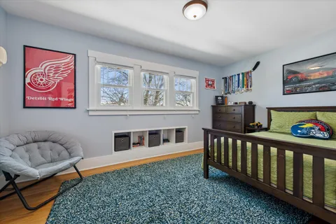 a bedroom with furniture and a rug